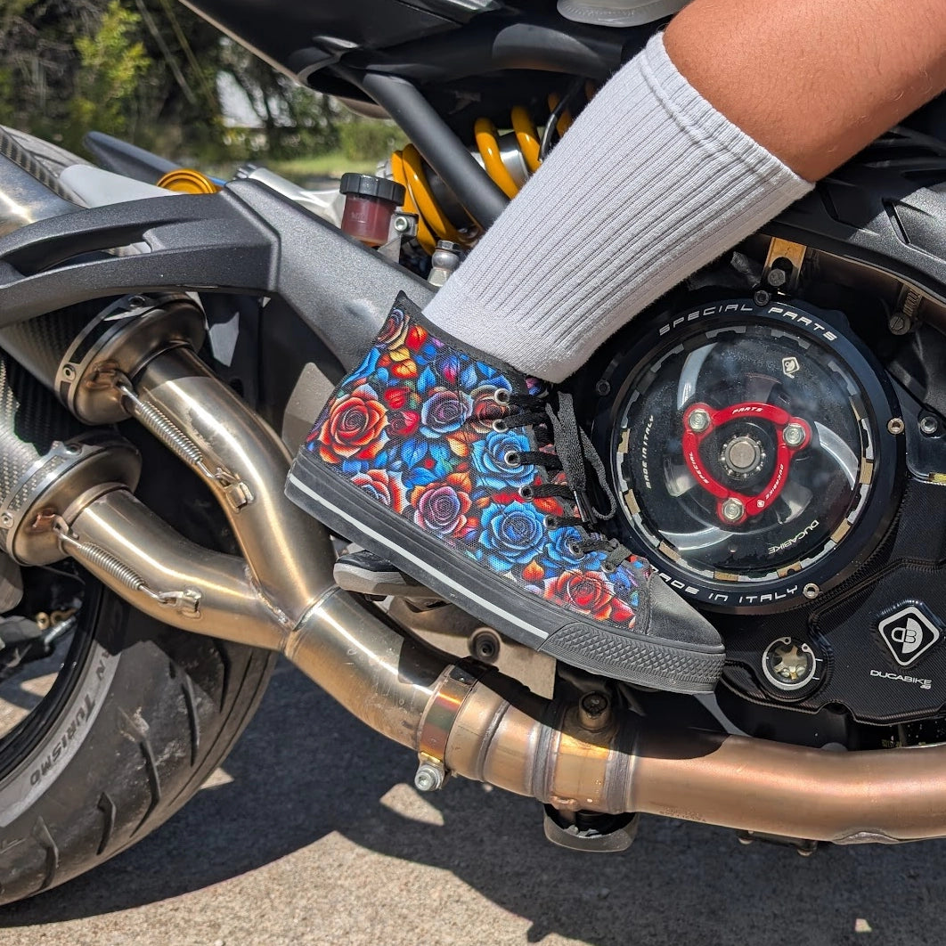 Colorful floral-patterned shoe on a motorcycle engine